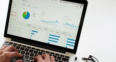 View of laptop screen displaying data analysis.