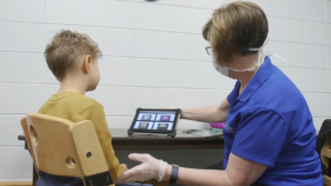 Speech Therapist demonstrating communication device