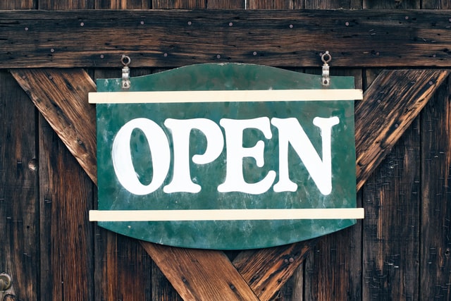 Rustic sign which reads "Open"